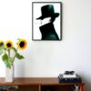 side profile illustration of a woman with a hat and coat that covers most of her face smoking a cigarette hanging on a wall in the living room