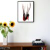 illustration of two legs seen from the back with heels on and red accents on the heels and legs hanging on a wall in the living room