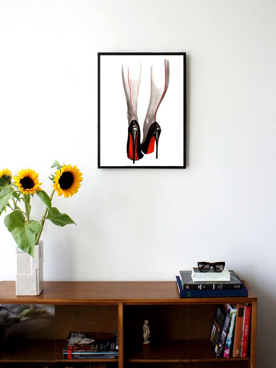 illustration of two legs seen from the back with heels on and red accents on the heels and legs hanging on a wall in the living room