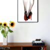 illustration of two legs seen from the back with heels on and red accents on the heels and legs hanging on a wall in the living room
