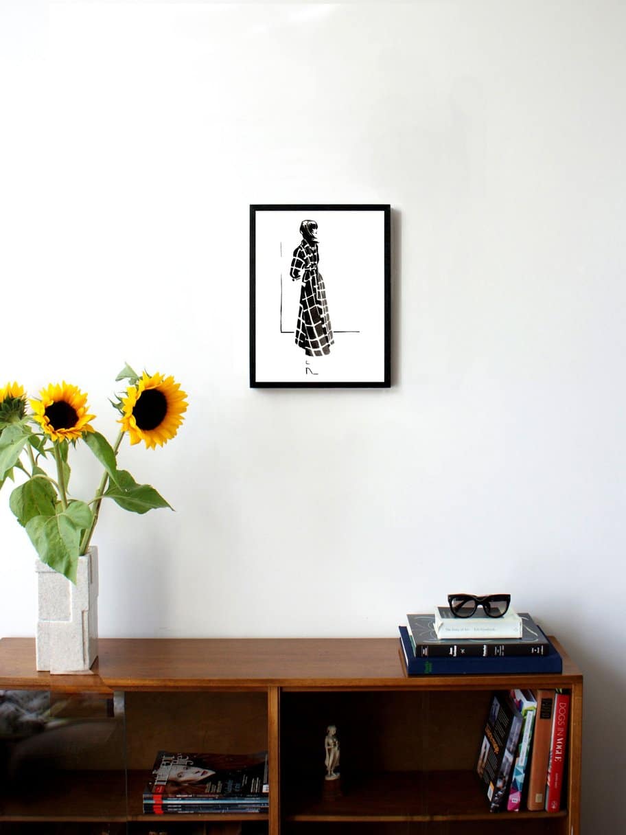 black and white illustration of a woman's side profile in a checkered long coat hanging on a wall in the living room