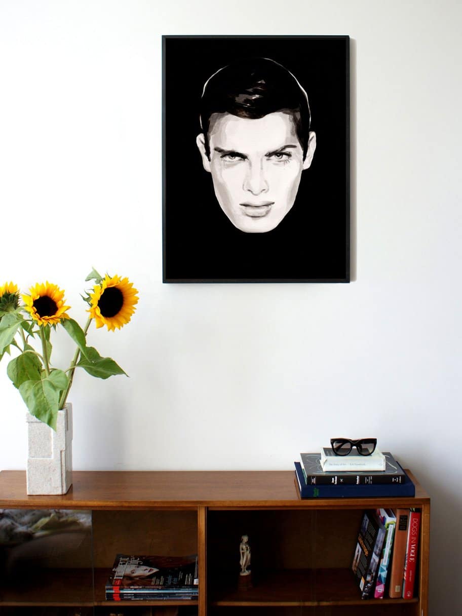 illustration of a face looking at you with a black background hanging of the wall in the living room