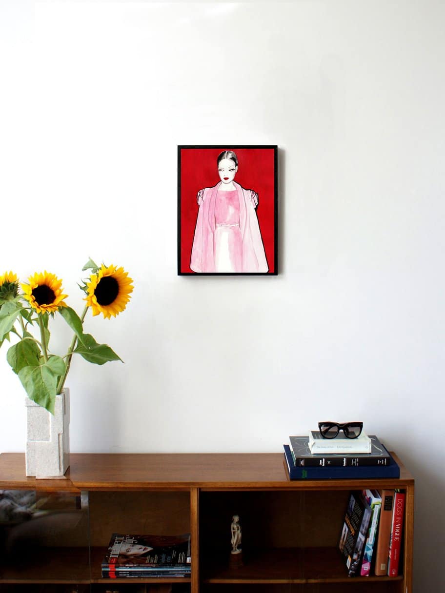 illustration of a woman with a pink dress looking away with red background hanging on the wall in the living room