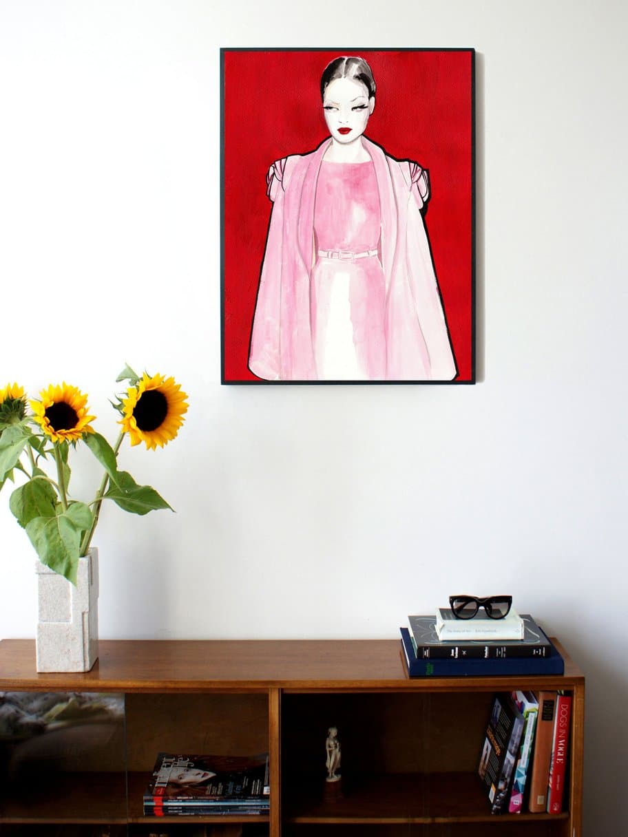 illustration of a woman with a pink dress looking away with red background hanging on the wall in the living room