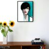 illustration of a woman with short dark hair and blue details hanging on a wall in the living room