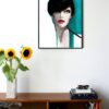 illustration of a woman with short dark hair and blue details hanging on a wall in the living room