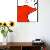 illustration of a womans face with a big red scarf around her neck hanging on a wall in the living room