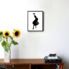 illustration in black and white of a woman posing in a skirt hanging on a wall in the living room