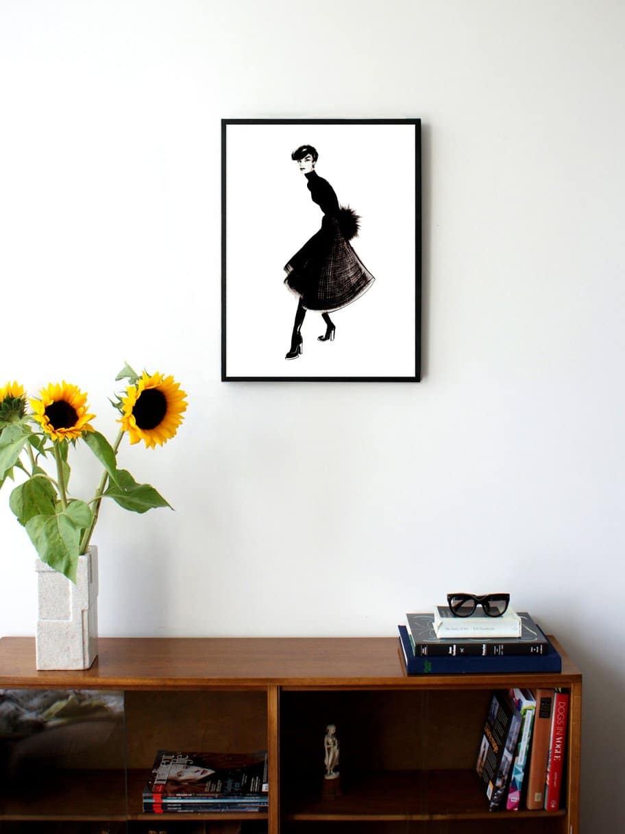 illustration in black and white of a woman posing in a skirt hanging on a wall in the living room